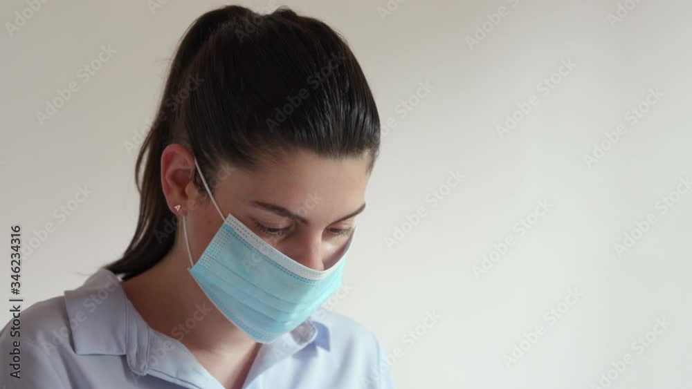 Young doctor putting on a protective mask. Women medical worker prepares herself to do her job. Safety concept. Young doctor putting on a protective mask. Women medical worker prepares herself to do her job. Safety concept.