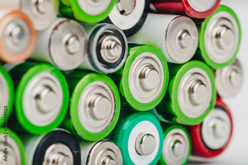 Closeup of group of used disposable batteries of various color. Closeup of group of used disposable batteries of various color.