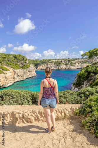 A girl surprised by the beauty of the landscape in Caló del Moro , Palma de Mallorca © Pic&shoot