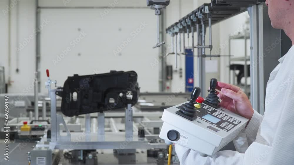 engineer performs accurate 3D measurements of plastic casting on an automatic robotic machine, production of plastic parts for the automotive industry engineer performs accurate 3D measurements of plastic casting on an automatic robotic machine, production of plastic parts for the automotive industry