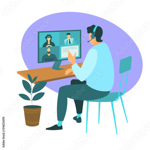 A man from home participates in a video conference with colleagues at work