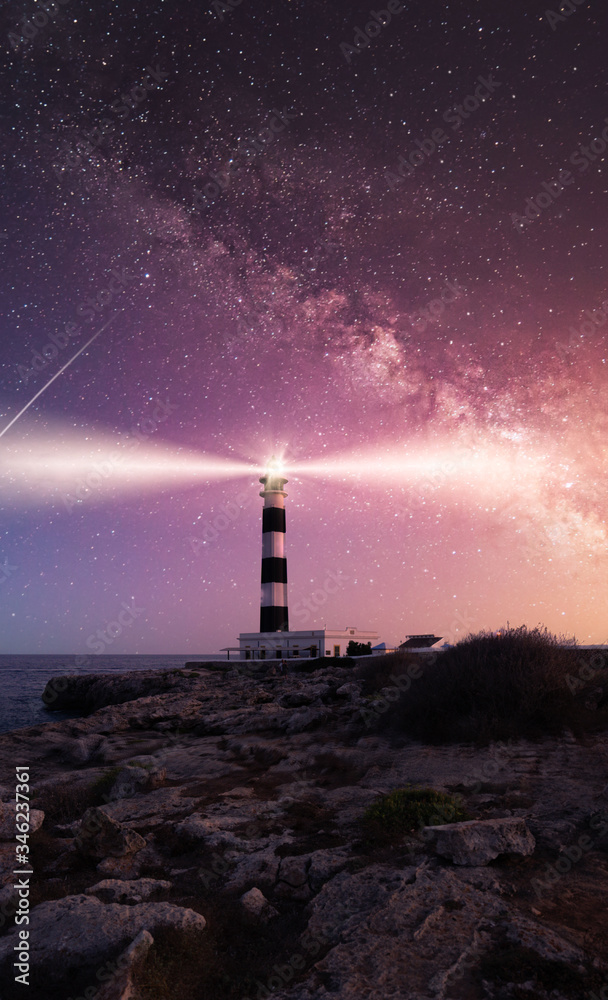 Vibrant Milky Way composite image over landscape Cap Artrutx Lighthouse on the Spanish mediterranean island of Menorca