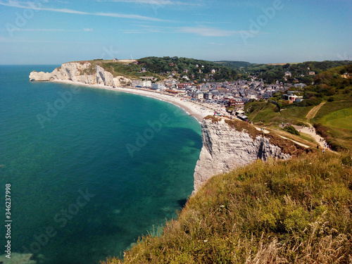 White cliffs edge and beach and Village of Étretat. Normandy. France.