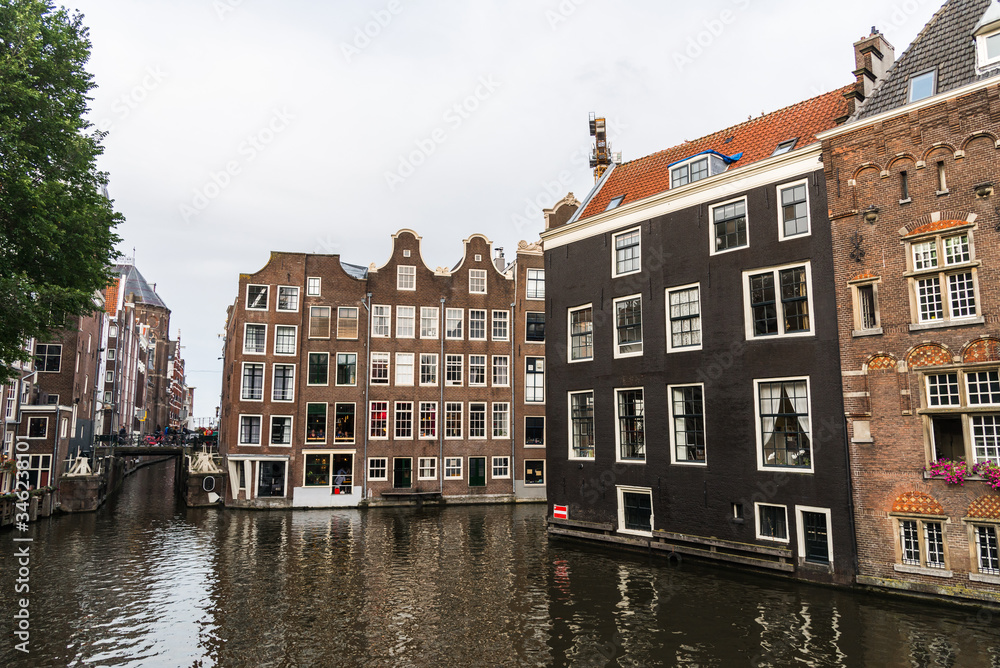 Water canals and traditional Dutch architecture colorful houses in Amsterdam, Netherlands