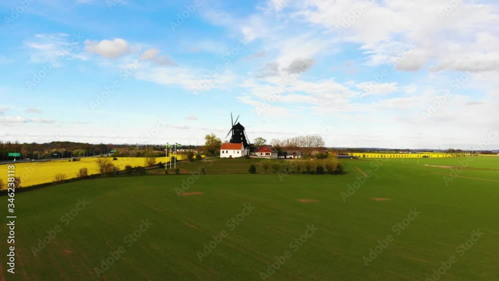 Drone approaching windmill flying over green field. Sweden springtime Drone approaching windmill flying over green field. Sweden springtime