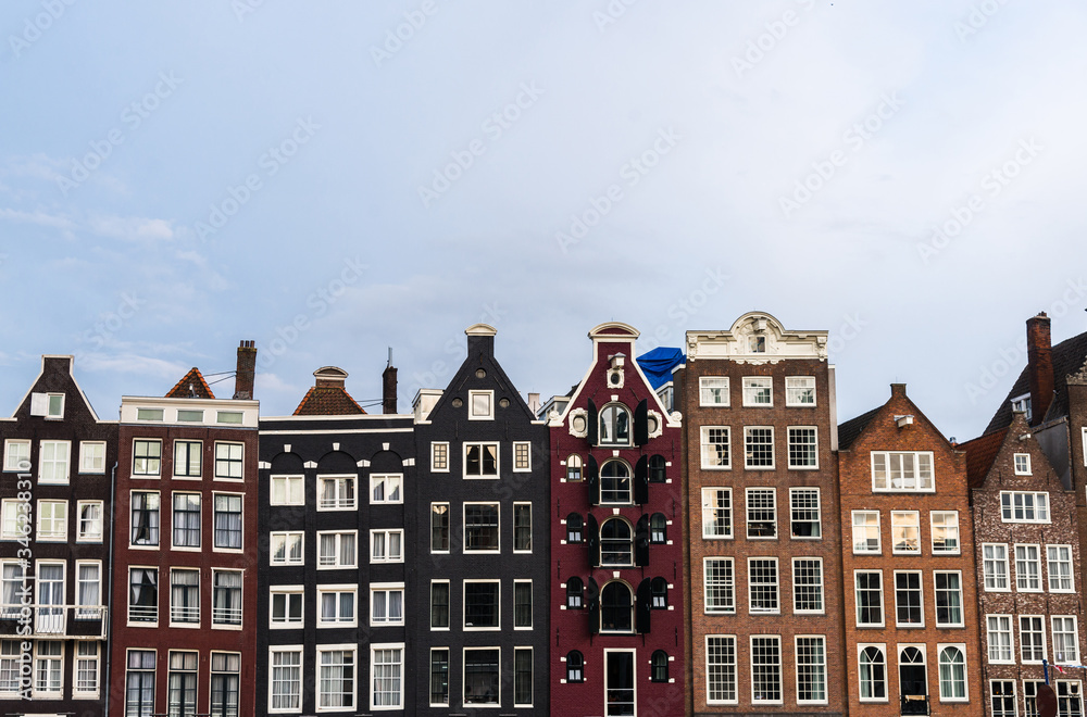 Traditional Dutch architecture colorful houses at Damrak in Amsterdam, Netherlands