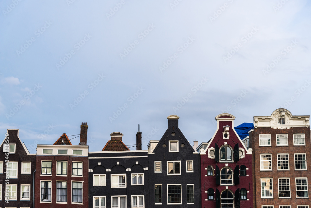 Traditional Dutch architecture colorful houses at Damrak in Amsterdam, Netherlands