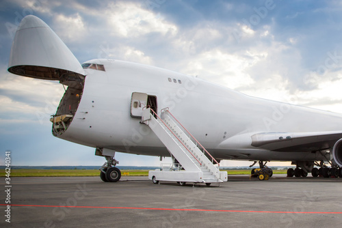 Bild auf Leinwand Unloading widebody cargo aircraft at the airport apron