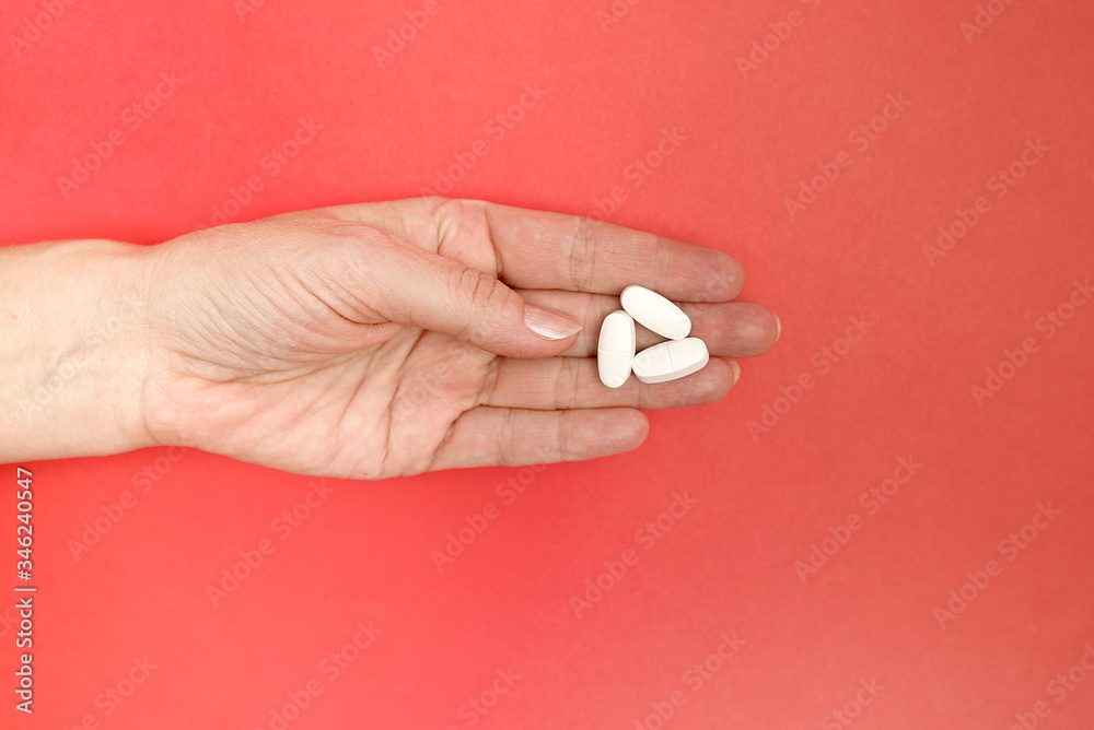medicine in woman's hands against red background against viruses and other diseases medicine in woman's hands against red background against viruses and other diseases