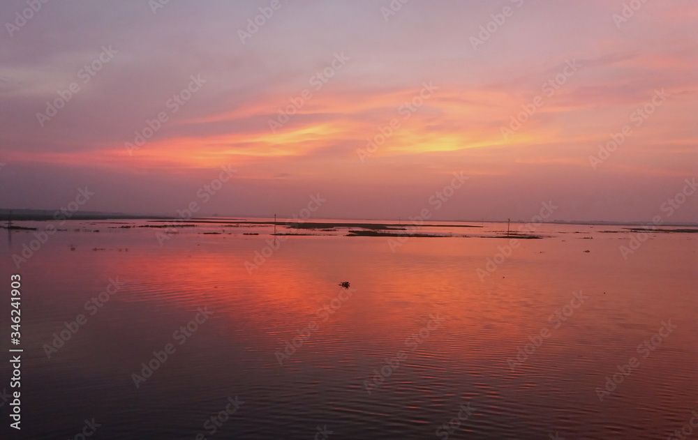 Beautiful  image of Bangladesh river with red sky in the background.