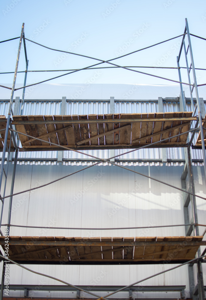 Fototapeta premium building wooden metal from scaffolding pipes bottom view background place for text