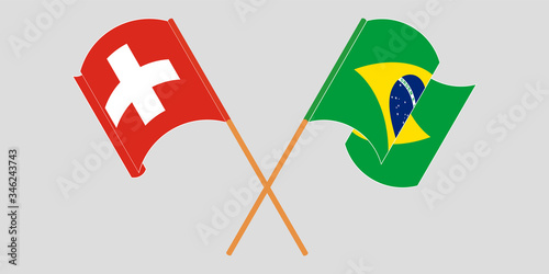 Crossed and waving flags of Switzerland and Brazil