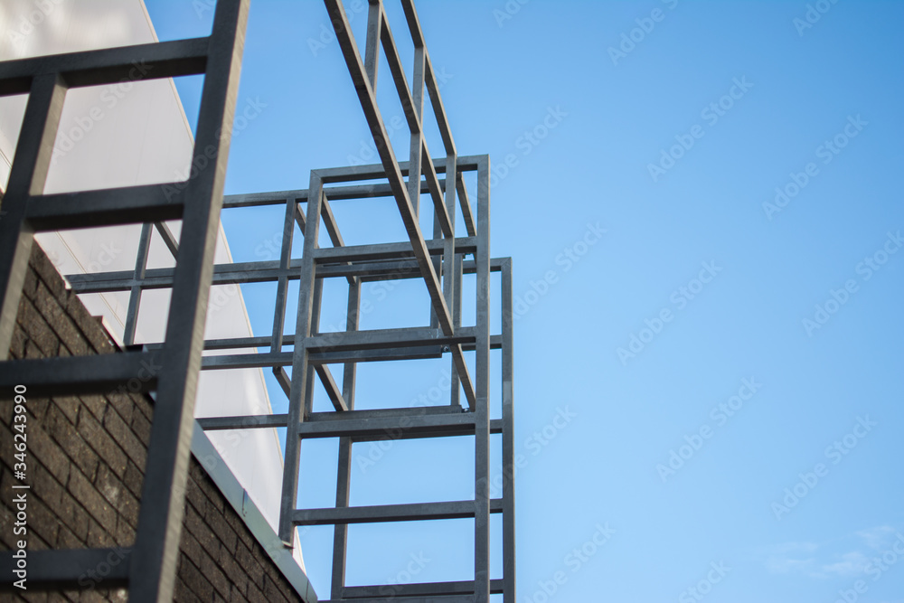metal structures made of pipes of a building under construction against the blue sky metal structures made of pipes of a building under construction against the blue sky