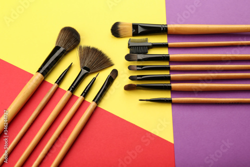 colorful flat lay with makeup brushes and products