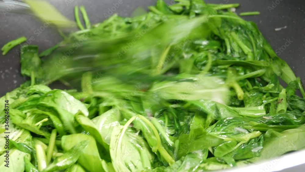 Water spinach is fried using hot cooking oil in a pan. Stir-fried with onion and anchovies and water. Water spinach is fried using hot cooking oil in a pan. Stir-fried with onion and anchovies and water.