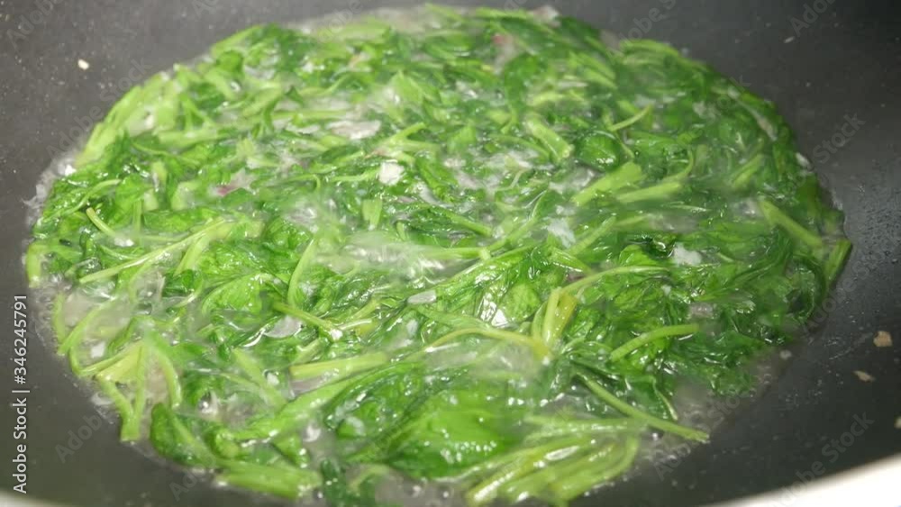 Water spinach is fried using hot cooking oil in a pan. Stir-fried with onion and anchovies and water. Water spinach is fried using hot cooking oil in a pan. Stir-fried with onion and anchovies and water.