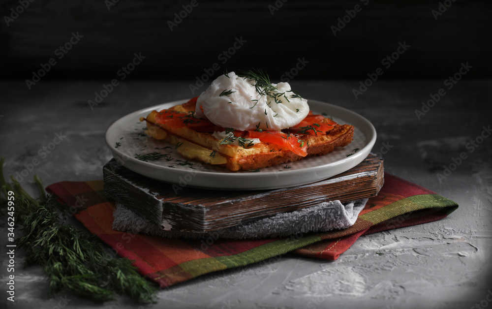 Belgian waffle with salmon and porched egg