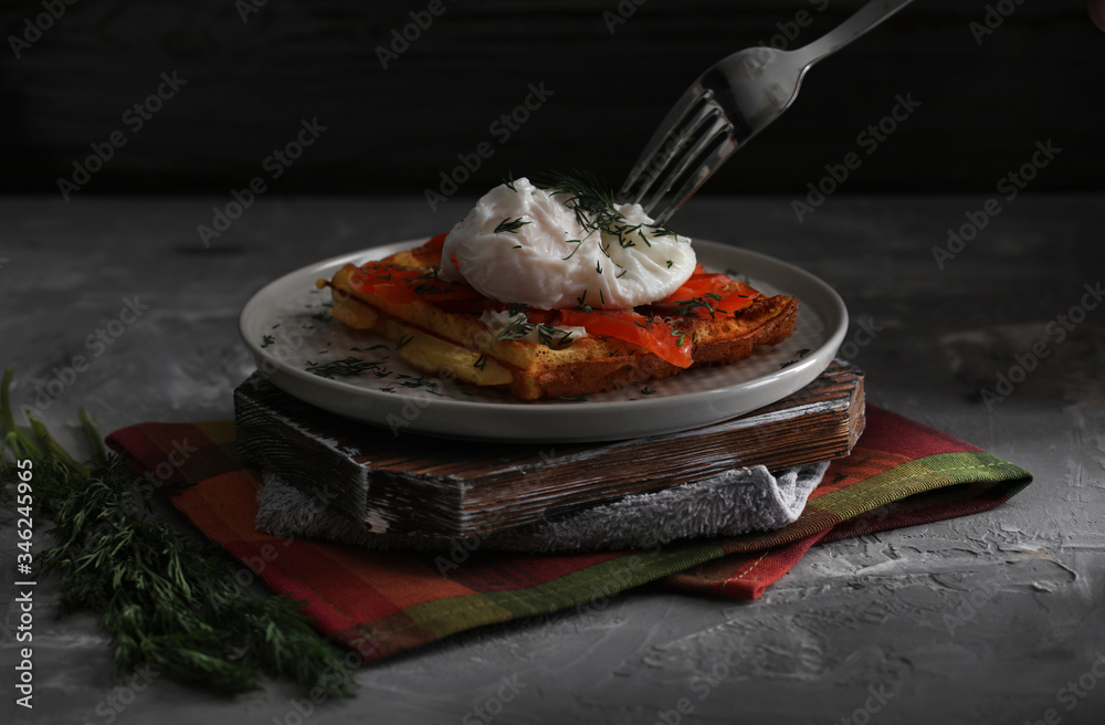 Belgian waffle with salmon and porched egg