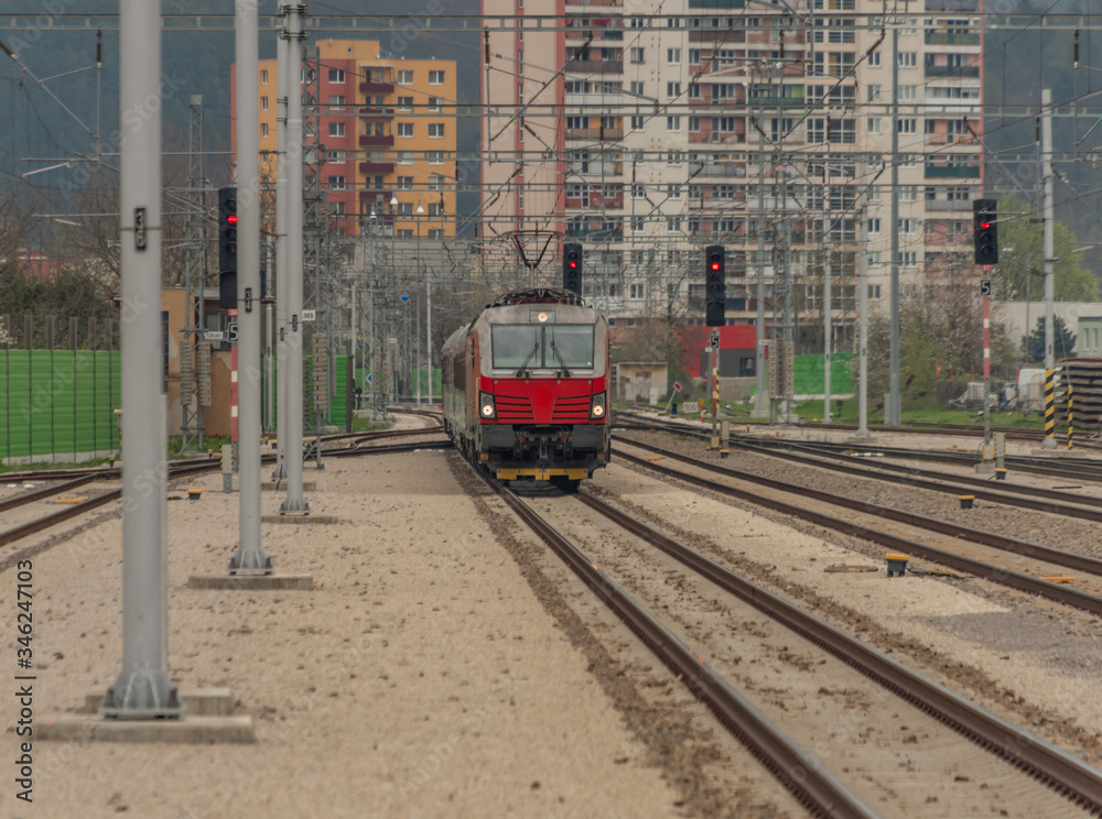 Obraz premium Fast passenger train with red modern electric engine in Trencin station