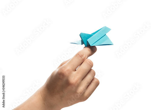 Blue paper plane in human palm. Concept of booking plane ticket, charters, tour. Isolated on white.