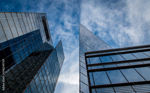 Tall glass skyscrapers against a blue sky with white clouds