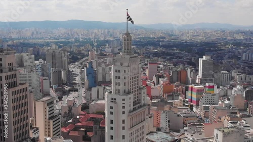 Aerial view of Altino Arantes building, called Banespao with the flag fluttering, at sunset, Sao Paulo downtown, Brazil photo