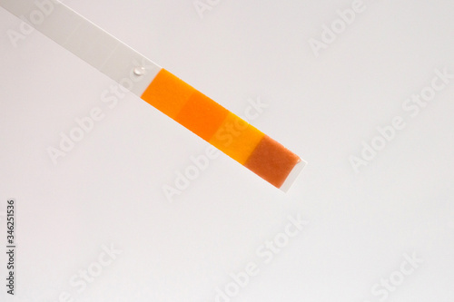 Closeup of a used pH paper test strip. Visual color laboratory test for testing liquids.