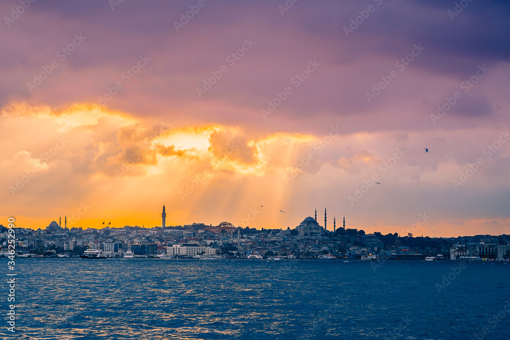 Istanbul at sunset, Turkey. Beautiful sunny view of the Istanbul waterfront with a mosque. A boat trip on the Bosphorus at sunset.