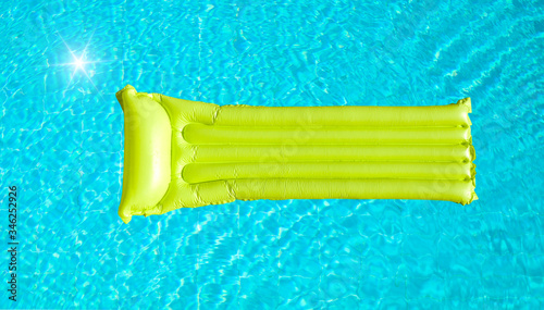 green inflatable mattress on blue pool