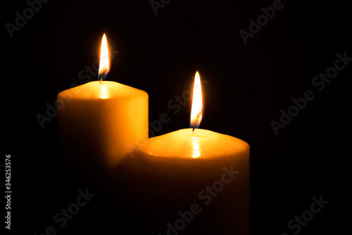 Flame candles isolated on black background. Close up.