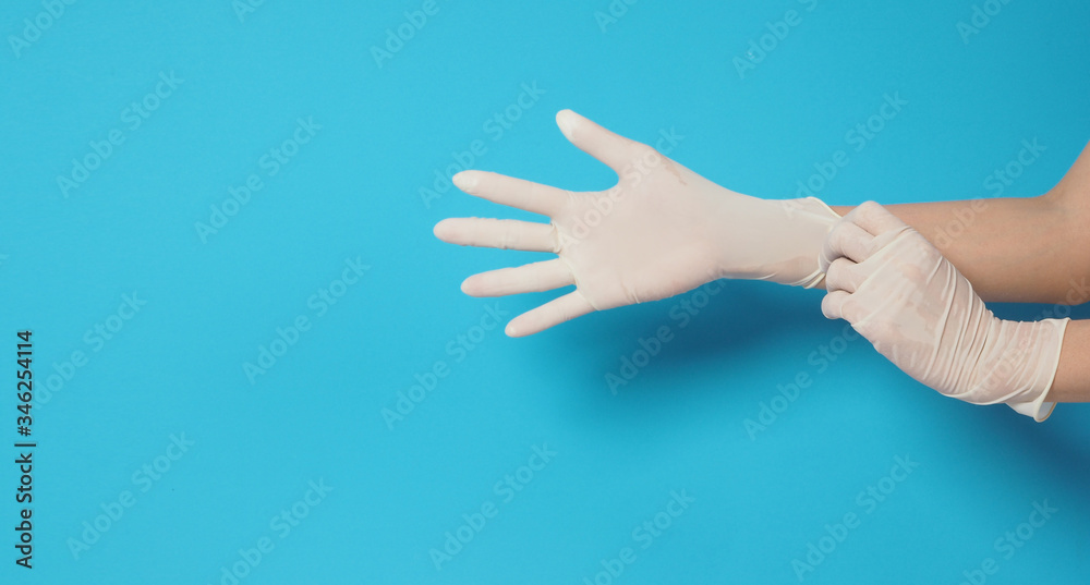 Two hand wearing white gloves and left hand is pulling.Put on blue background.