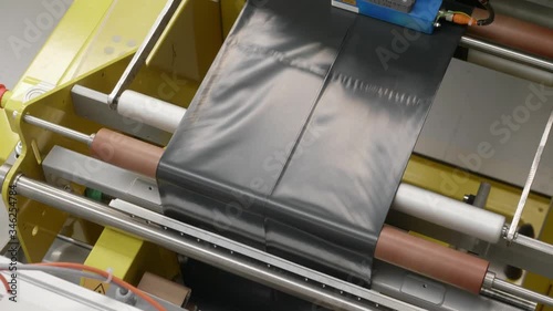 Machine producing Plastic Bags and Trash Bags. Plastic production inside Modern Plastic Film Factory.