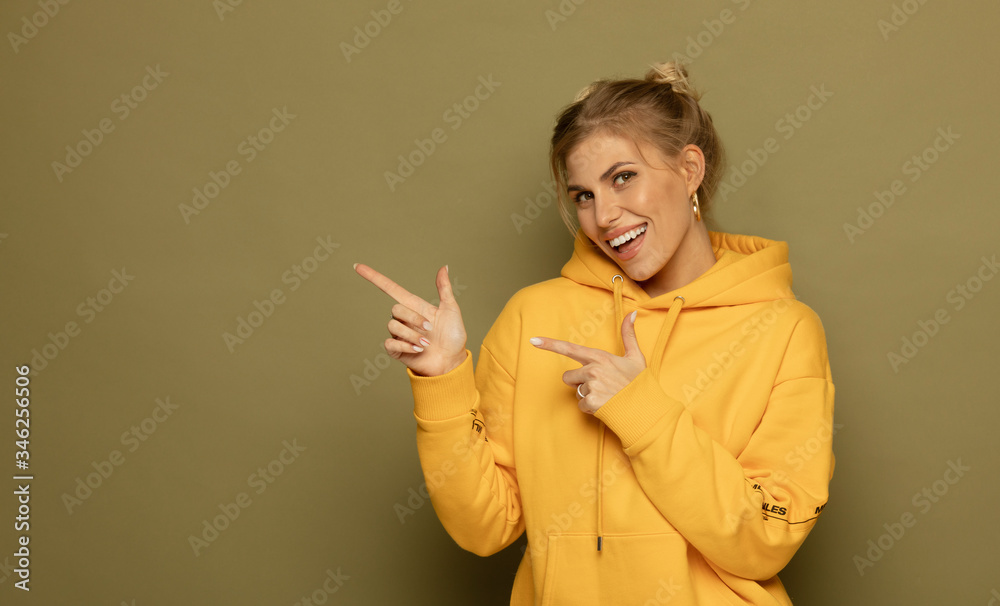 Photo of happy young woman standing isolated over green background. Looking camera showing copyspace pointing. Photo of happy young woman standing isolated over green background. Looking camera showing copyspace pointing.