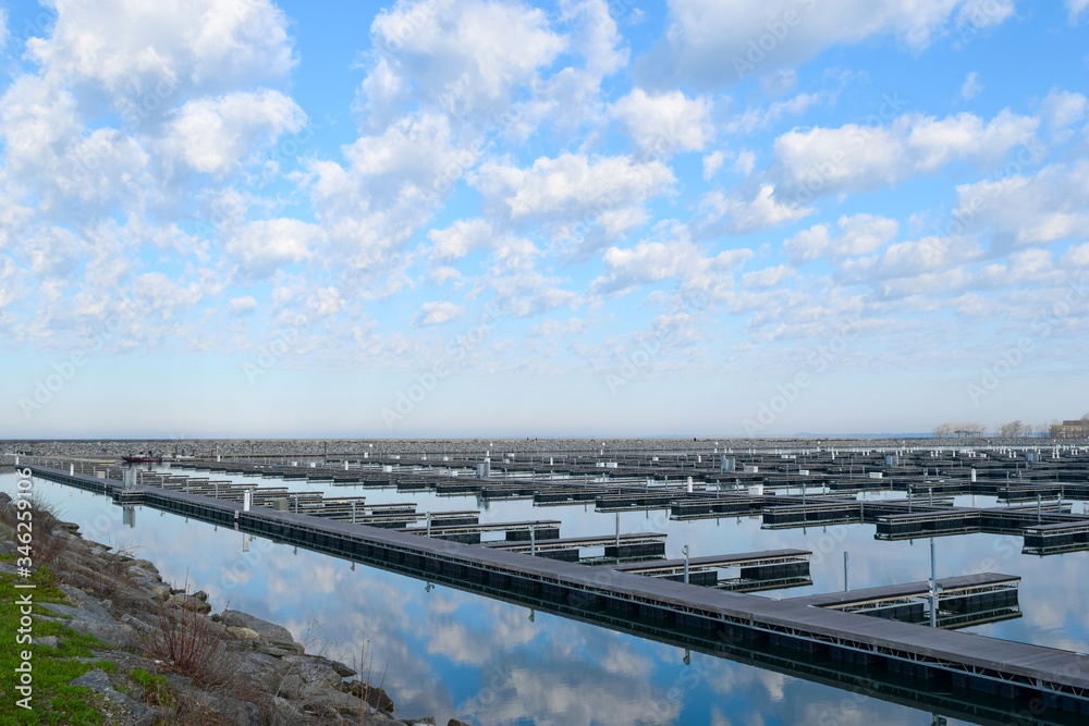 Fototapeta premium Boat Dock & Marina Empty Awaiting Boating & Shipping Season on Water, Lake, River & Ocean