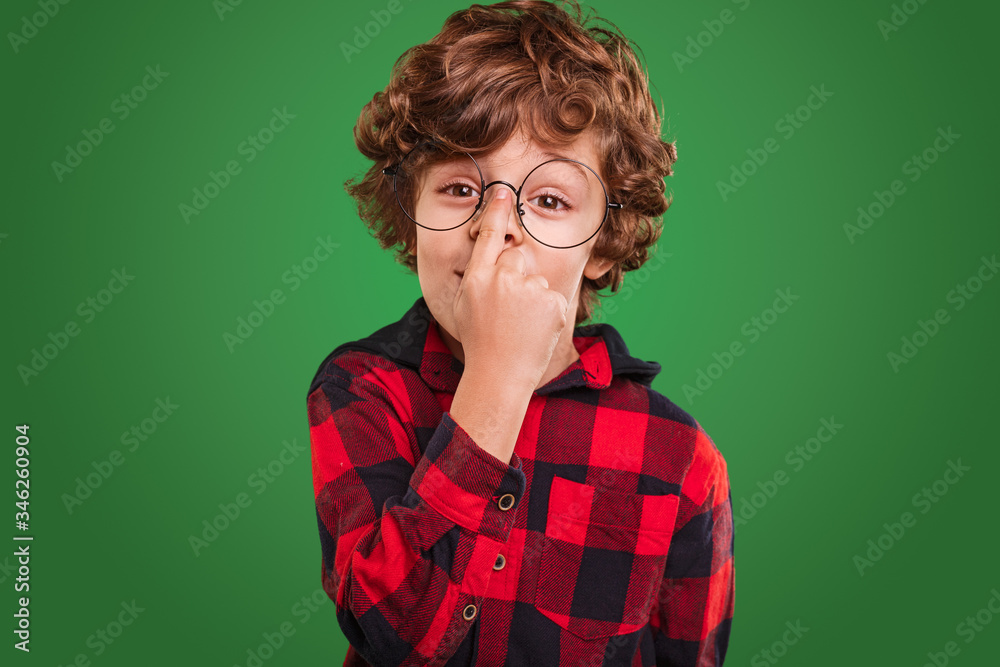 Smart boy adjusting round glasses Smart boy adjusting round glasses