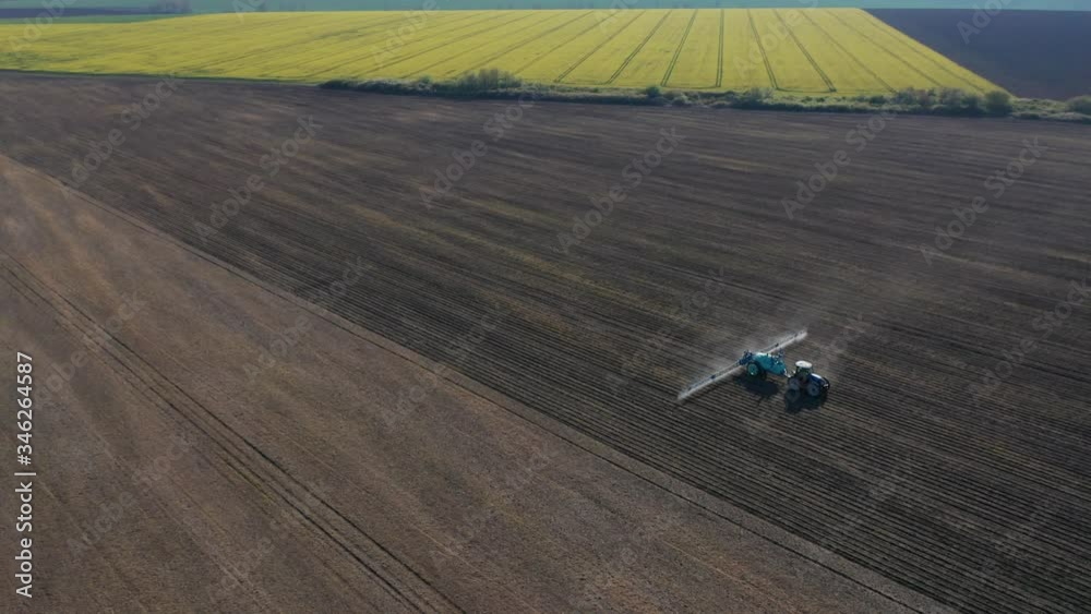 Aerial view of a tractor that irrigates the sown field through a special installation. Aerial view of a tractor that irrigates the sown field through a special installation.