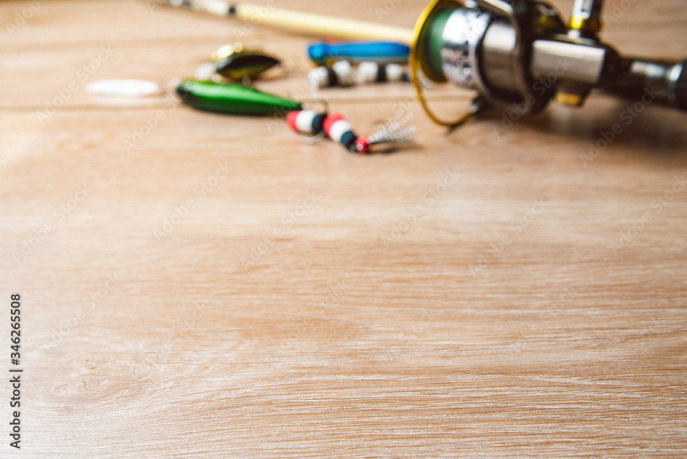Fishing tackle-fishing spinning, lures on a wooden background. Fishing tackle-fishing spinning, lures on a wooden background.