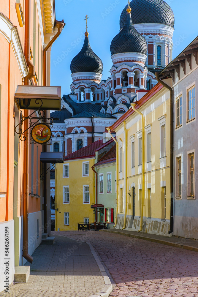 Obraz premium Tallinn, Estonia - ‎25 ‎April ‎2020. Alexander Nevsky Church on the side of a small, colorful street in the old city. Medieval architecture of the country. Colorful buildings.