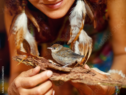Photography woman with a small bird. bird in hand.
