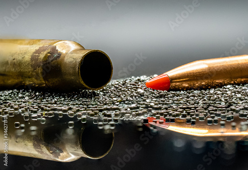 .223 caliber bullet and casing in gun powder.
