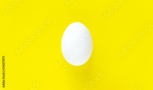 Easter egg on colorful bright yellow background