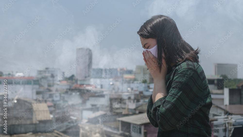 Woman coughing.Woman wearing face mask because of air pollution in the city