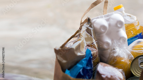 Food donation basket for people. The concept of quarantine assistance during the coronavirus pandemic. Food delivery. Volunteer assistance. Close-up.