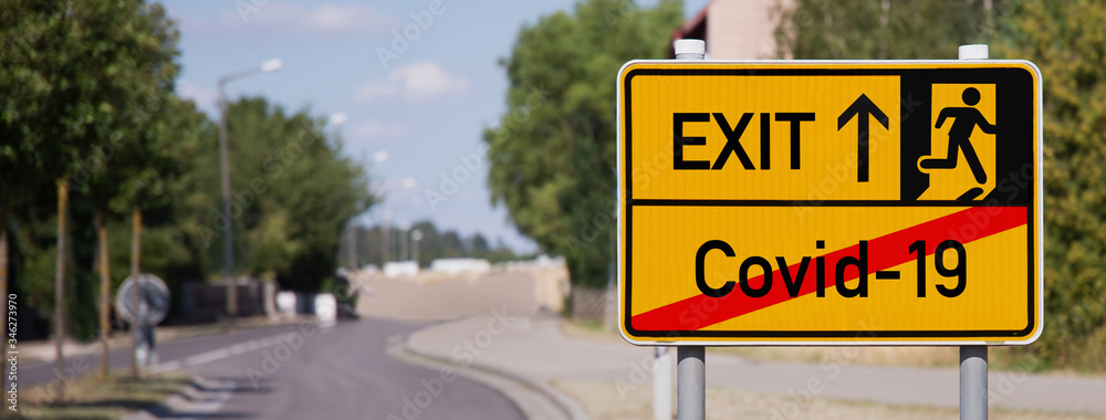 Yellow sign points away from Covid-19 to escape symbol Yellow sign points away from Covid-19 to escape symbol