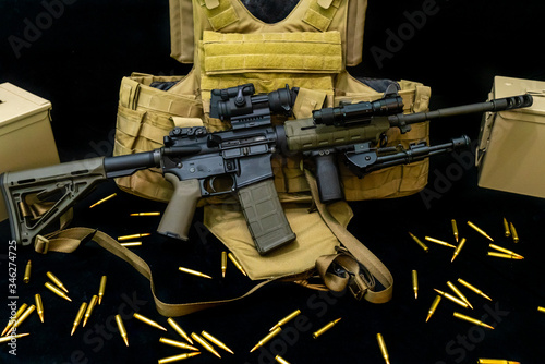 assault rifle with bulllets and tactical plate carrirer.