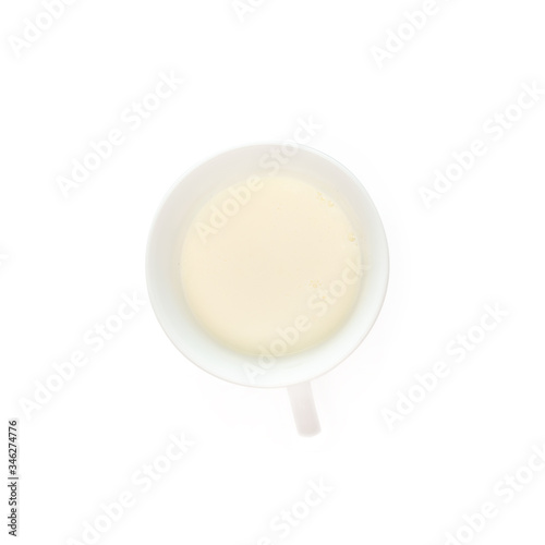 Milk in a cup isolated on white background, top view
