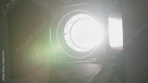 Footage of studio light being turned on and off. Floodlight flashes