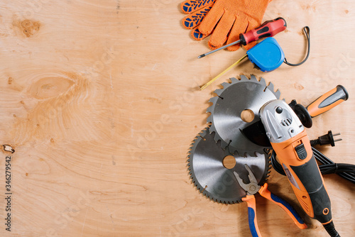Tela Angle grinder with accessories flatlay on wooden background