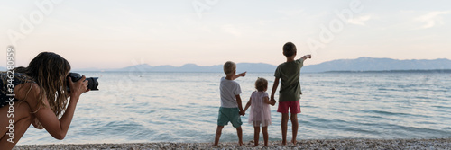 Wide view image of beautiful family moment on the beach at dusk