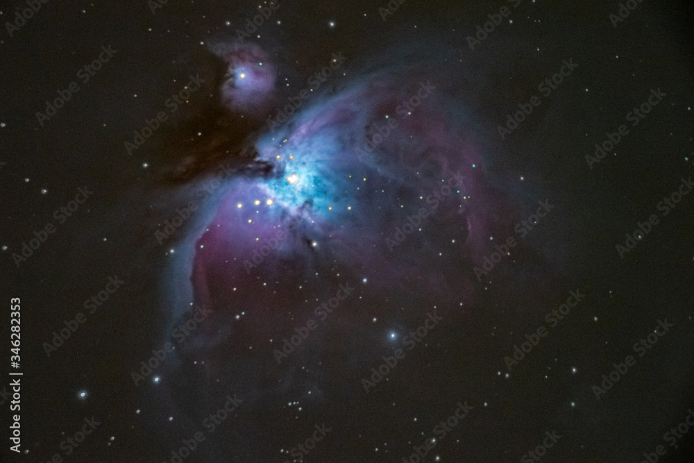 Beautiful nebulas in the constellation Orion called Orion nebula and Running Man nebula. High ISO long time exposure taken with photo camera and long focus telescope on tracking mount